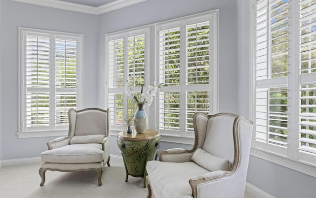 sitting room with carpet floors, a healthy amount of sunlight, and ornamental molding