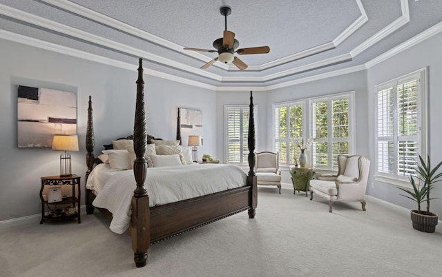 bedroom with a tray ceiling, ceiling fan, light colored carpet, and ornamental molding