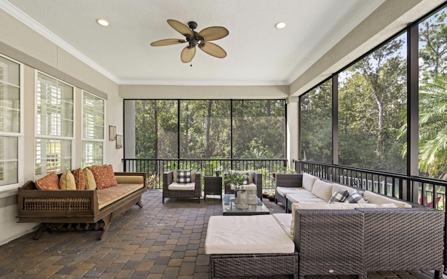 sunroom / solarium featuring plenty of natural light and ceiling fan