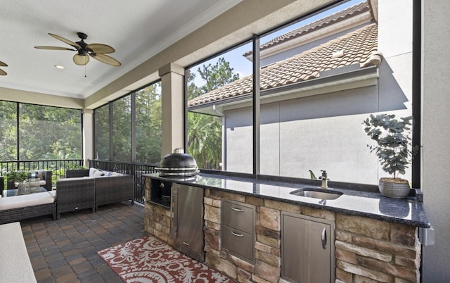 view of patio / terrace with ceiling fan, sink, exterior kitchen, and an outdoor hangout area