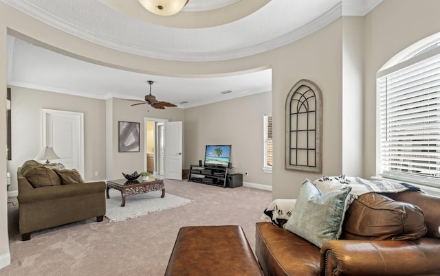 living room with light carpet, ceiling fan, a healthy amount of sunlight, and ornamental molding