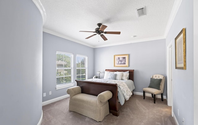 carpeted bedroom featuring a textured ceiling, ceiling fan, and crown molding