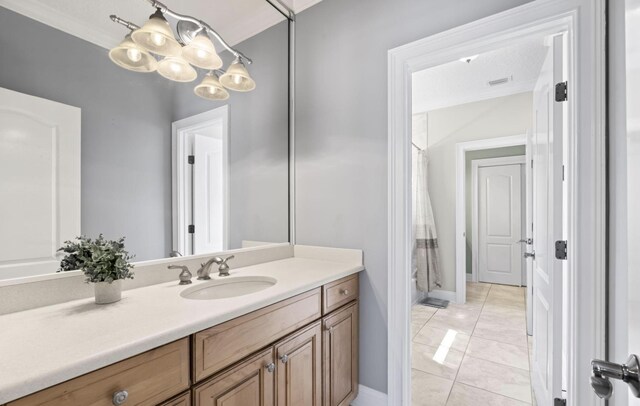 bathroom featuring tile patterned flooring and vanity