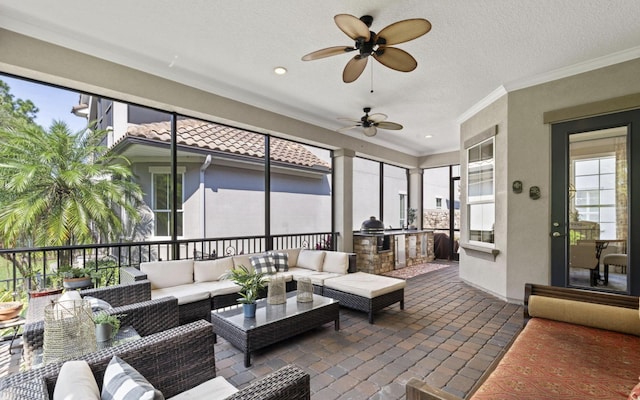 sunroom featuring ceiling fan