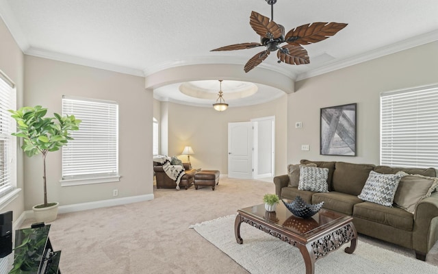 carpeted living room featuring ceiling fan and crown molding