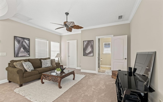 carpeted living room featuring crown molding, ceiling fan, and a healthy amount of sunlight