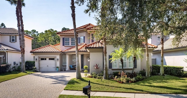 mediterranean / spanish-style house featuring a front lawn and a garage