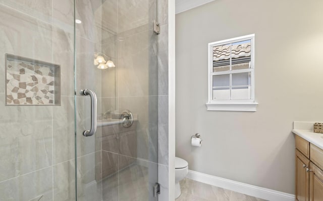 bathroom featuring vanity, toilet, and a shower with shower door