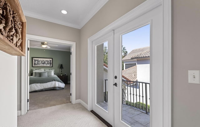 doorway with ceiling fan, light colored carpet, ornamental molding, and french doors