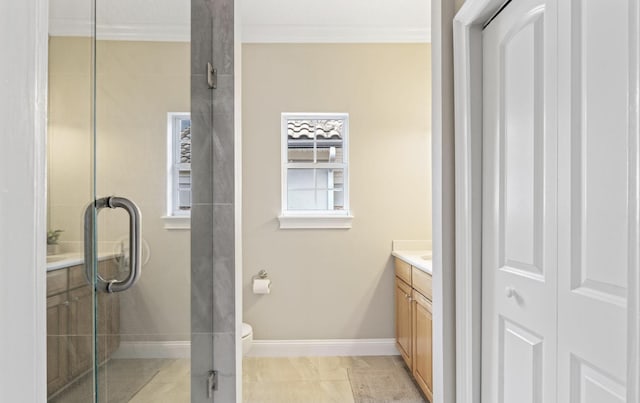 bathroom with vanity, toilet, an enclosed shower, and crown molding