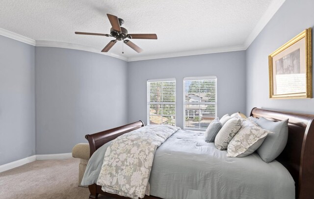 carpeted bedroom with ceiling fan, a textured ceiling, and ornamental molding