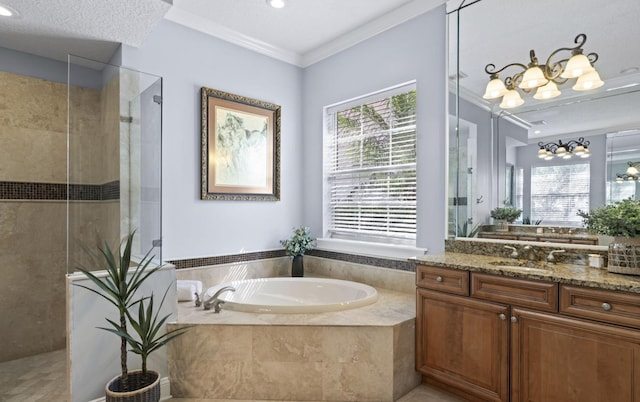 bathroom with vanity, a textured ceiling, crown molding, and a healthy amount of sunlight