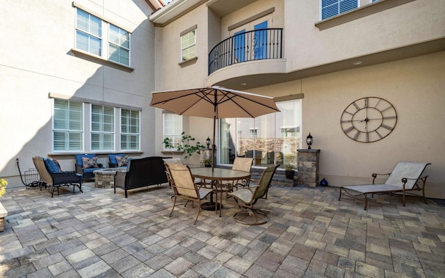 view of patio with an outdoor living space and a balcony