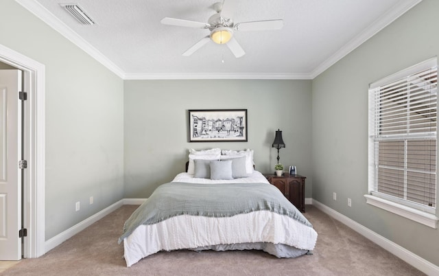 carpeted bedroom featuring a textured ceiling, ceiling fan, and crown molding