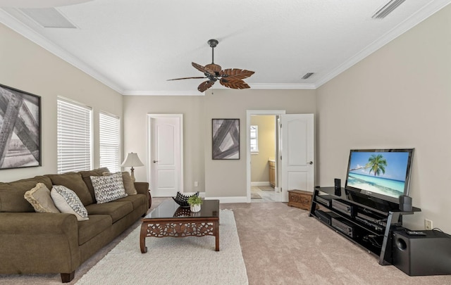 carpeted living room with ceiling fan and ornamental molding