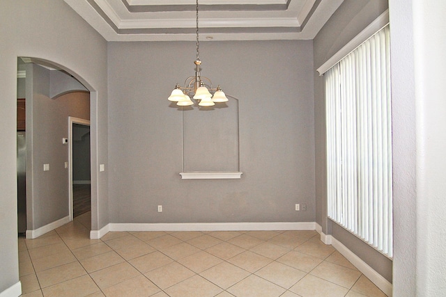 30 Fortress Pl, Palm Coast, FL 32137 - empty room featuring arched walkways, plenty of natural light, a raised ceiling, and light tile patterned flooring