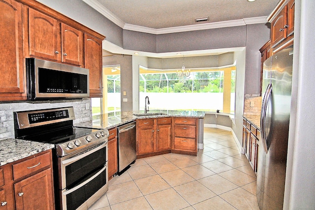 30 Fortress Pl, Palm Coast, FL 32137 - kitchen featuring stainless steel appliances, a sink, crown molding, a peninsula, and light tile patterned floors