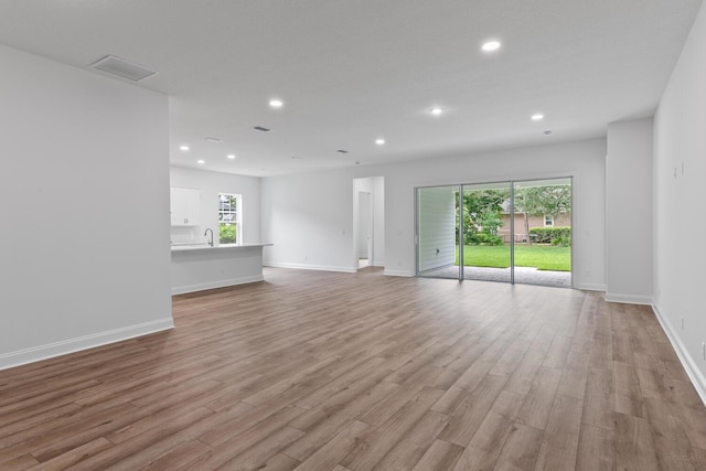 5013 Clayton Ct, Saint Augustine, FL 32092 - unfurnished living room featuring visible vents, light wood-style flooring, baseboards, and recessed lighting
