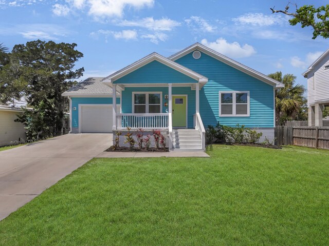 519 Arricola Ave, Saint Augustine, FL 32080 - view of front of property with driveway, a front lawn, a porch, a garage, and fence