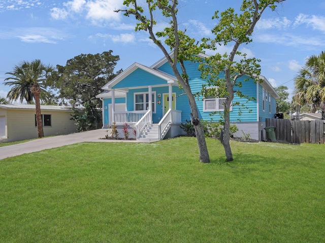 519 Arricola Ave, Saint Augustine, FL 32080 - view of front of home featuring a front yard, fence, covered porch, and concrete driveway