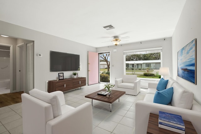 living room with visible vents, ceiling fan, and light tile patterned flooring