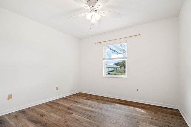 unfurnished room featuring wood finished floors, a ceiling fan, and baseboards