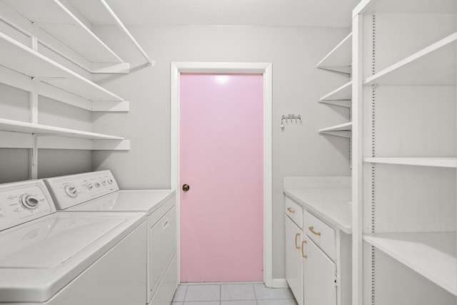 laundry area featuring cabinet space, washer and dryer, and light tile patterned flooring