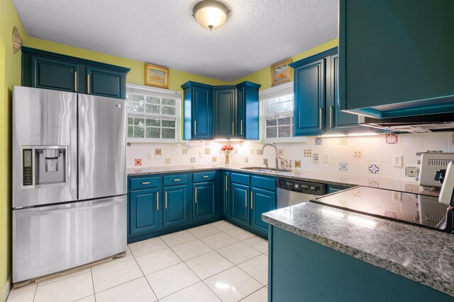 162 Martin Luther King Ave, Saint Augustine, FL 32084 - kitchen with stainless steel appliances, a textured ceiling, backsplash, dark stone counters, and light tile patterned floors