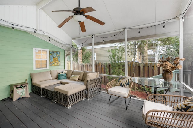 sunroom with ceiling fan and lofted ceiling