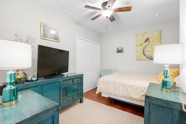 bedroom featuring hardwood / wood-style floors, a closet, and ceiling fan