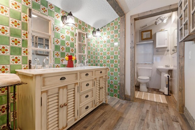 162 Martin Luther King Ave, Saint Augustine, FL 32084 - bathroom with wood finished floors, wallpapered walls, a textured ceiling, and lofted ceiling