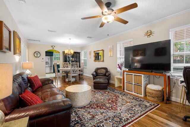 162 Martin Luther King Ave, Saint Augustine, FL 32084 - living area featuring a chandelier, wood finished floors, a ceiling fan, crown molding, and a textured ceiling