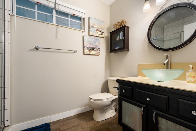 bathroom with hardwood / wood-style floors, vanity, and toilet