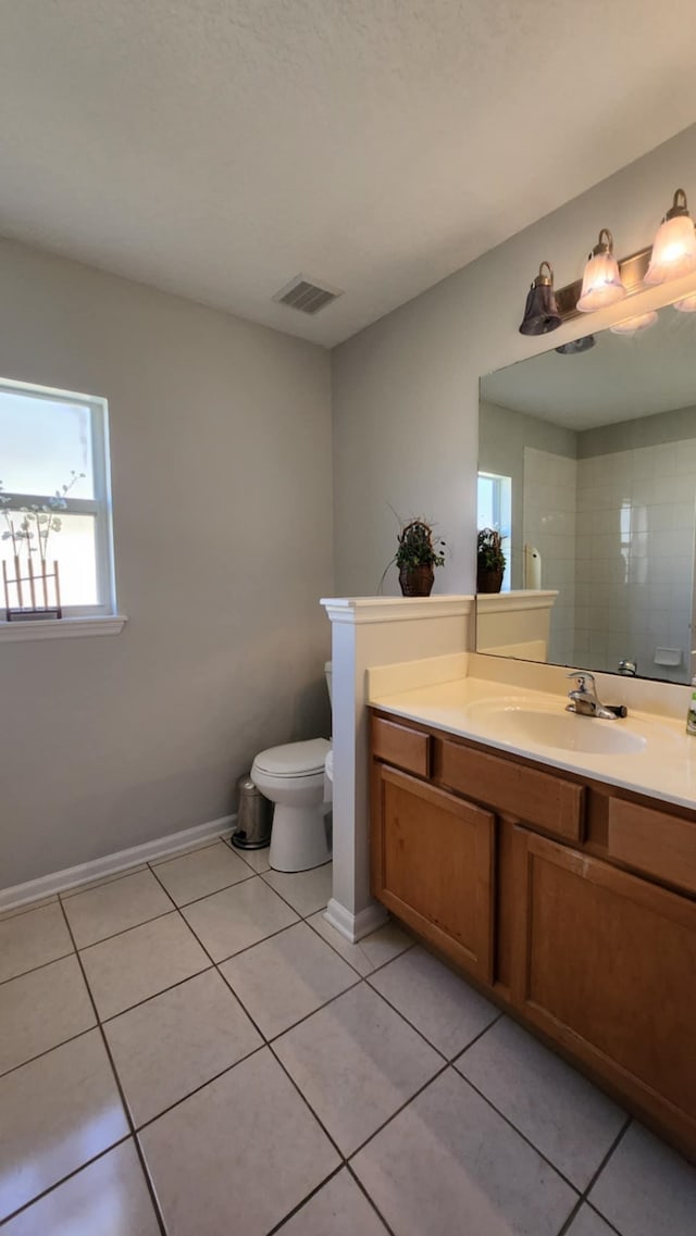 bathroom with tile patterned floors, toilet, vanity, and baseboards