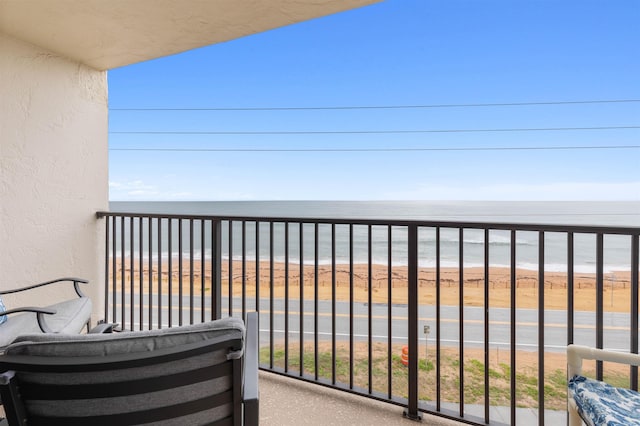 balcony with a view of the beach and a water view