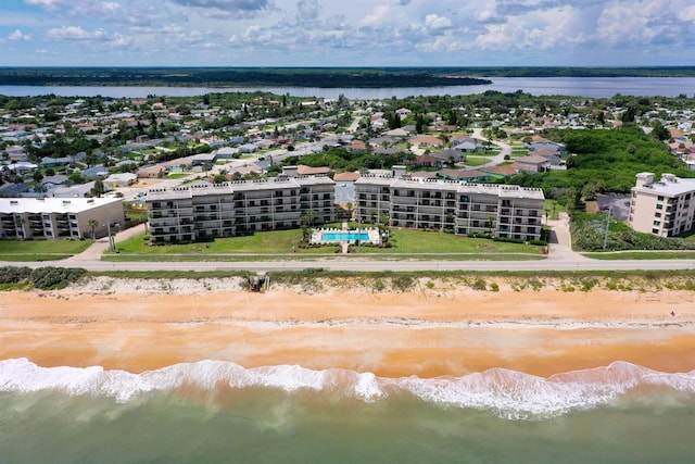 drone / aerial view featuring a beach view and a water view