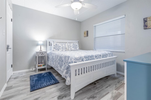 bedroom with ceiling fan and light wood-type flooring