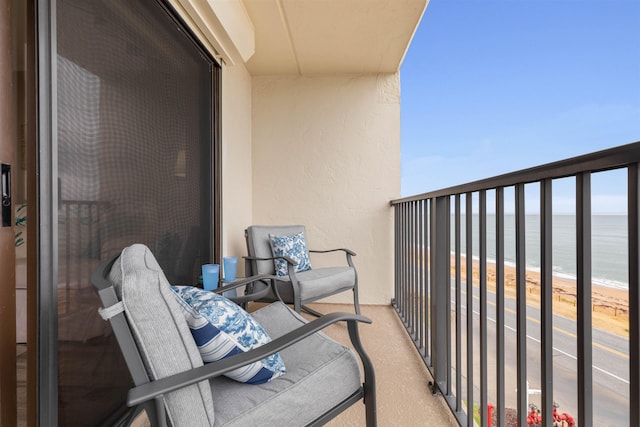 balcony with a view of the beach and a water view