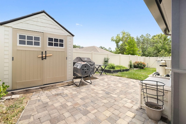 196 Sawmill Forest Ct, Saint Augustine, FL 32086 - view of patio featuring a fenced backyard, a storage shed, an outbuilding, and a grill