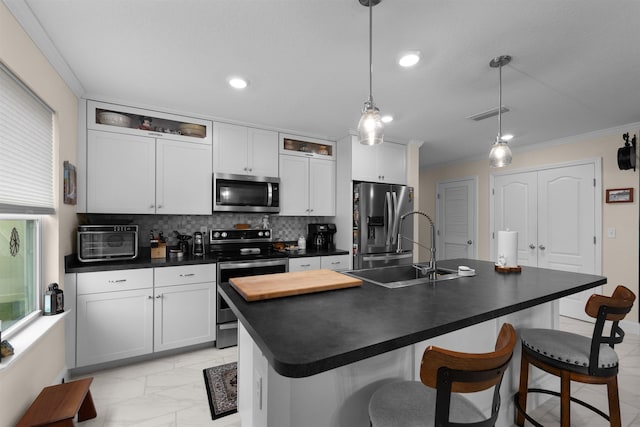 196 Sawmill Forest Ct, Saint Augustine, FL 32086 - kitchen with stainless steel appliances, dark countertops, light marble finish flooring, a kitchen breakfast bar, and tasteful backsplash