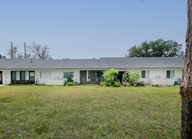 9 Kings Colony Ct Unit 9, Palm Coast, FL 32137 - view of front of property with a front lawn and a shingled roof