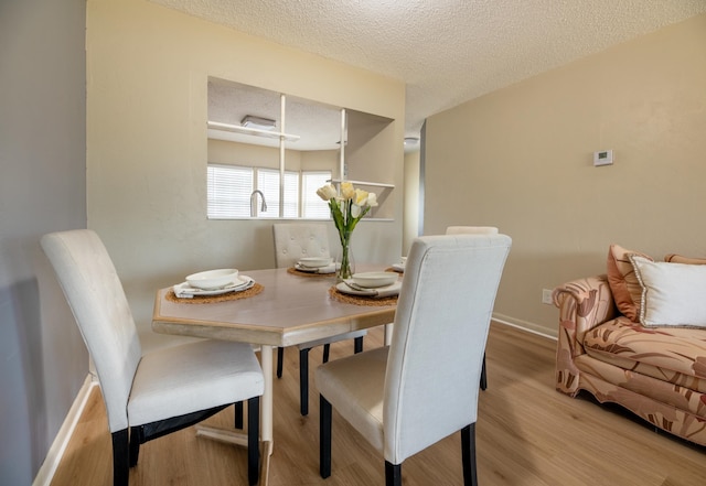 9 Kings Colony Ct Unit 9, Palm Coast, FL 32137 - dining space featuring wood finished floors, a textured ceiling, and baseboards