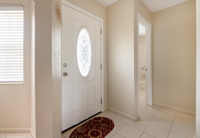 9 Kings Colony Ct Unit 9, Palm Coast, FL 32137 - entryway featuring plenty of natural light, baseboards, and light tile patterned flooring