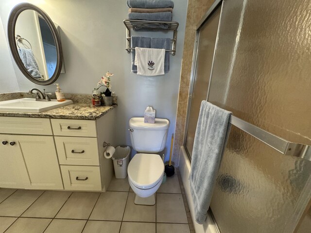 66 Village Del Lago Cir, Saint Augustine, FL 32080 - bathroom with tile patterned floors, vanity, shower / bath combination with glass door, and toilet