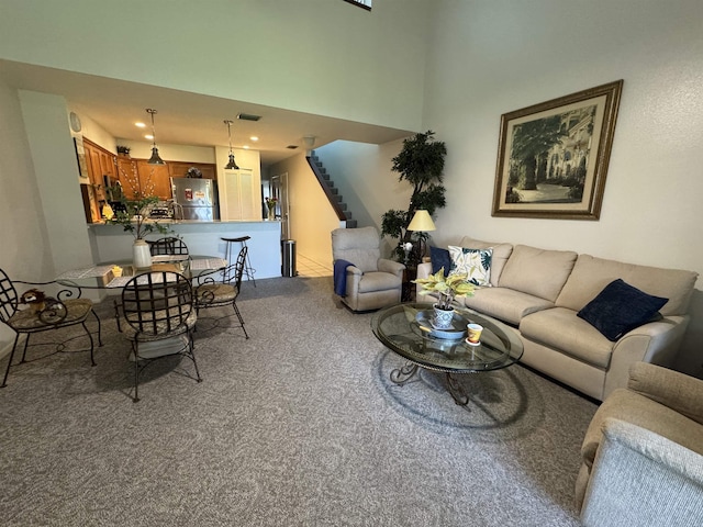 66 Village Del Lago Cir, Saint Augustine, FL 32080 - carpeted living room with a high ceiling, recessed lighting, stairs, and visible vents