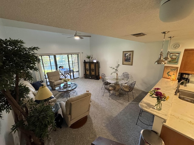 66 Village Del Lago Cir, Saint Augustine, FL 32080 - living area with carpet floors, a textured ceiling, visible vents, and ceiling fan