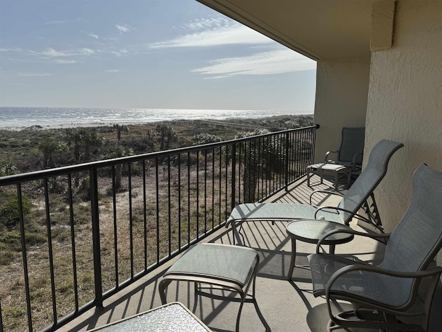 balcony with a water view and a beach view