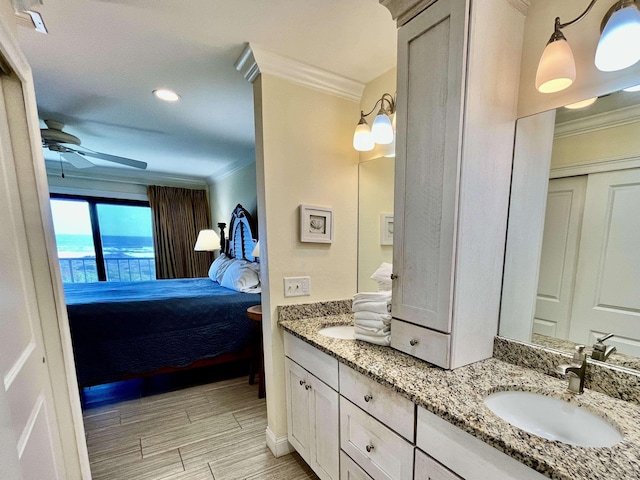 full bath featuring wood tiled floor, ornamental molding, a sink, and ensuite bathroom