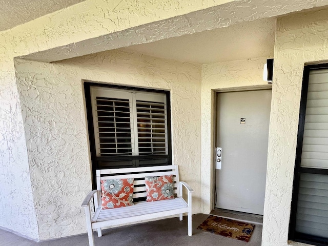 entrance to property with stucco siding