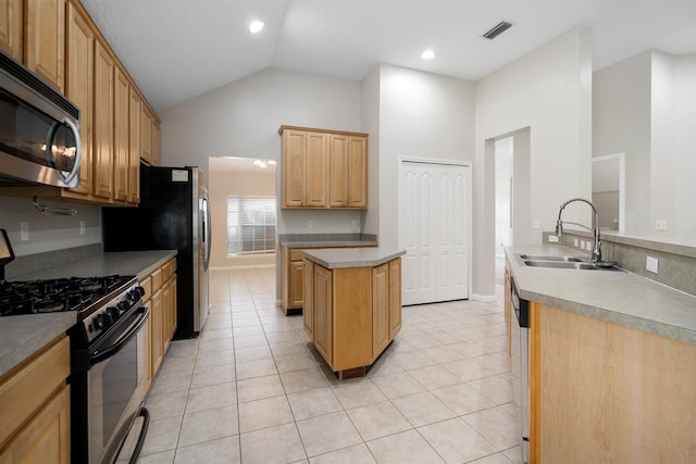 kitchen with stainless steel appliances, sink, high vaulted ceiling, a center island, and light tile patterned flooring